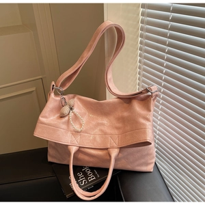 Pink glossy tote bag with pearl bow charm detail and textured pleated PU leather