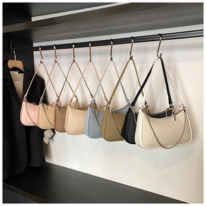 Close-up of woven texture crescent shoulder bags in multiple colors with chain straps