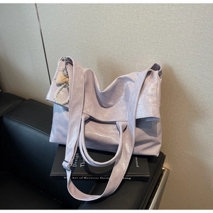 Detail of light purple tote bag with glossy pleated texture and pearl ribbon charm