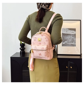Rear view of a pink mini backpack with KEBU letter print and front zipper pocket detail