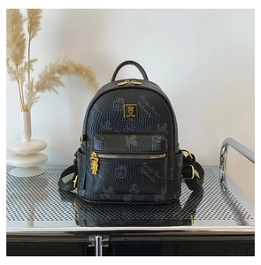 Detail of black pebbled leather backpack with Teddy Bear University print and gold logo