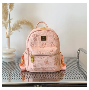 Detail of pink mini backpack featuring teddy bear prints and metal bear zipper charm