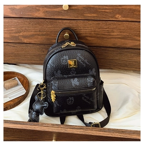 Detail of black pebbled leather backpack with Teddy Bear University print and gold hardware