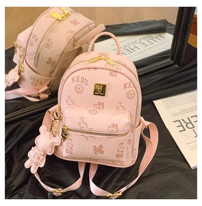 Detail of light pink mini backpack with bear pattern and metal logo on satin background