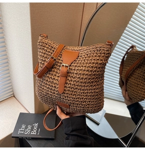 Detail of woven straw crossbody bag featuring leather accents and a stylish metal buckle