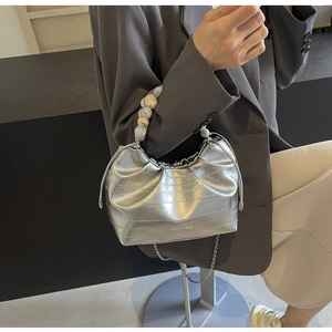 Detail of silver pleated cloud bag with beaded handle and fashion text design