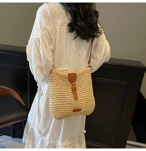 Close-up of natural woven straw texture with brown leather strap and buckle detail
