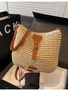 Chic beige straw woven crossbody bag with brown leather strap and metal buckle