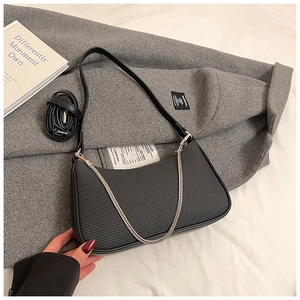 Detail of black half-moon shoulder bag with fabric splicing and silver metal chain
