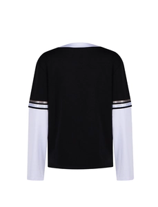 Detail view of the black and white long sleeve shirt with athletic patchwork design