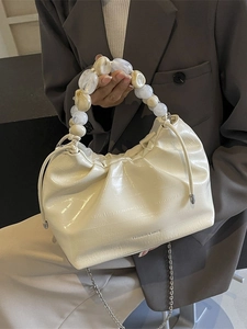 Creamy white pleated dumpling bag with large bead handle and metal shoulder chain