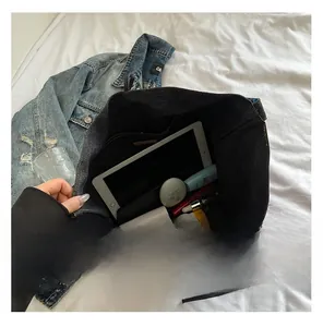 Interior view showing the large capacity of the denim tote bag with everyday essentials