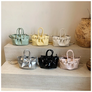 Detailed collection of vintage bucket tote bags in six colors on minimalist stone steps