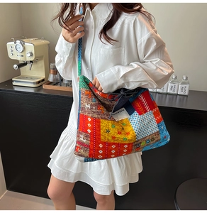 Detailed close-up of a large bohemian patchwork tote bag with colorful ethnic patterns