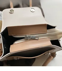 Detail of silver metal zipper and smooth sliding puller on contrast leather handbag