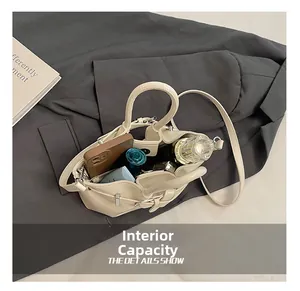 Interior view showing the large capacity of the beige bucket bag for cosmetics and phone
