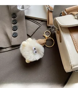 Close-up of cute plush charm with knit hat on a premium handbag for work