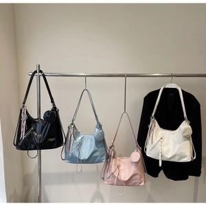 Detailed close-up of four colorful hobo bags hanging with small round coin purses