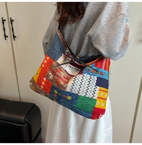 Close-up of colorful patchwork denim tote bag with black drawstring and SEEYOU label