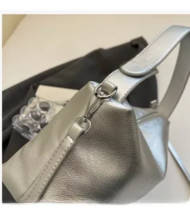 Close-up of metallic silver pillow bag featuring premium polished hardware details