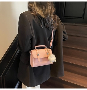 Chic pink leather handbag detail with silver studs and cute pompom charm detail