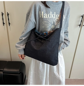 Detail of large dark grey canvas tote bag with bow tie and interior floral lining