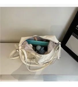 Interior view of the spacious cream tote bag showing capacity for tablets and daily items