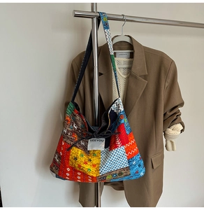Detail of bohemian patchwork tote bag featuring geometric patterns and drawstring closure