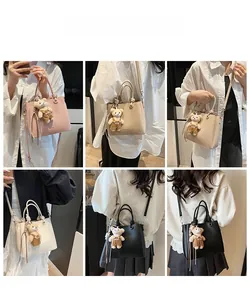 Detailed views of the solid color bucket bag featuring a cute plush bear charm
