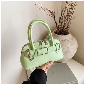 Close-up of mint green seashell handbag with lychee pattern and silver buckle hardware