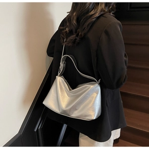 Detailed shoulder view of a large silver matte tote bag with soft metallic texture