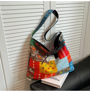 Detailed shot of ethnic patchwork canvas crossbody bag with vibrant geometric patterns