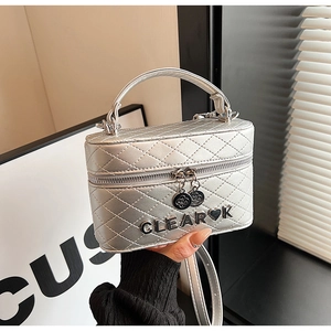 Détail du sac bandoulière argenté matelassé avec lettrage métallique CLEAR en cœur