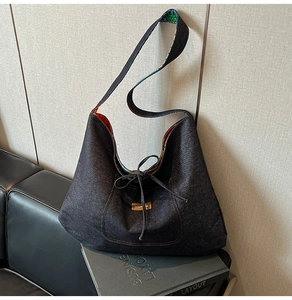 Detail of denim tote bag showing grey twill texture and contrast floral print lining