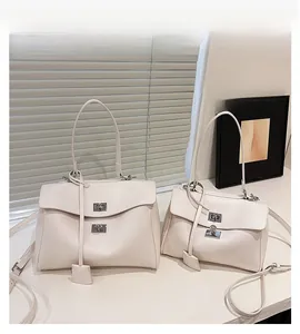 White leather tote bags in large and small sizes with silver metal twist locks and straps