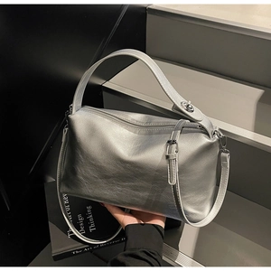 Close-up of matte silver Boston bag showing smooth leather texture and metal strap details