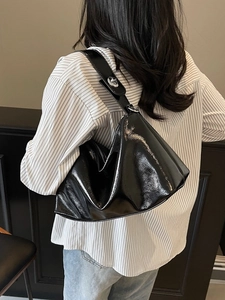 Modern black glossy patent leather shoulder bag with silver hardware for women