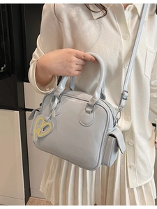 Light blue Boston tote bag with top handles and heart pendant for women, 2026 style