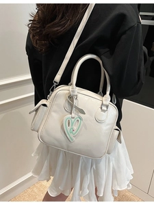 Women's off-white Boston tote bag with large capacity and heart charm, model view