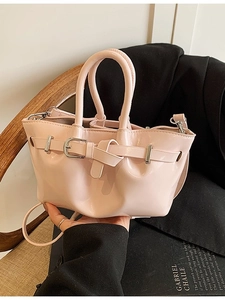 Retro light pink patent leather bucket bag with top handles and stylish metal buckle strap