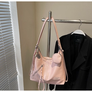 Détail du sac cabas en cuir mat rose avec petit porte-monnaie rond et pompon tressé
