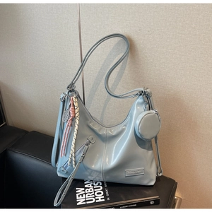 Fashion light blue hobo tote bag in glossy finish with decorative tennis racquet pendant