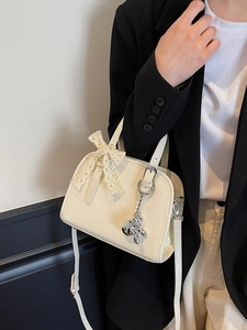 Creamy patent leather Boston shoulder bag with lace bow and rabbit charm detail