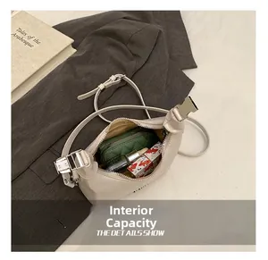 Top view of cream leather crossbody bag interior showing storage for wallet and lipstick