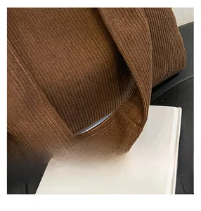 Close-up of durable brown corduroy tote bag showing reinforced strap stitching detail