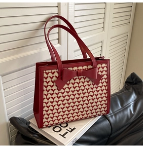 Detail of red bow ornament and heart pattern on large capacity tote bag surface
