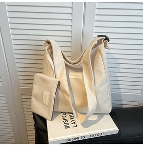 Detailed texture of corduroy tote set including a large shoulder bag and small pouch