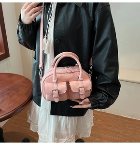 Sac bowling rose brillant porté par un mannequin avec double poignées et bandoulière
