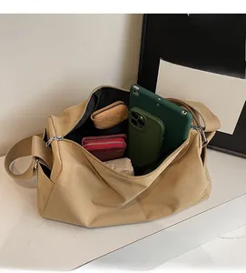 Top view of large khaki canvas bag interior showing space for tablet and wallet