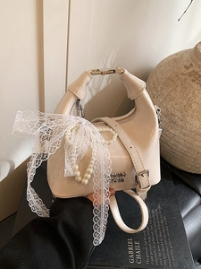 Elegant beige patent leather dumpling bag with lace bow and pearl chain handle